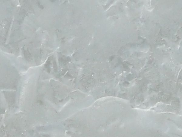 Smooth ice texture, formed with an irregular white marbling effect in its surface.